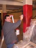 Mike Borkan helps with the painting.